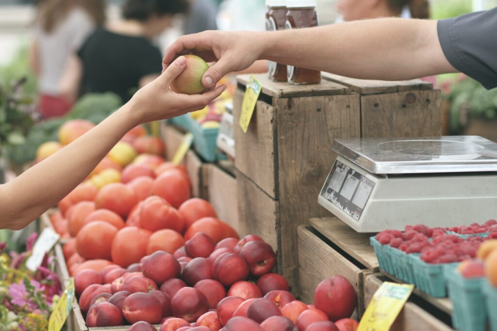 fruit being purchased at a market